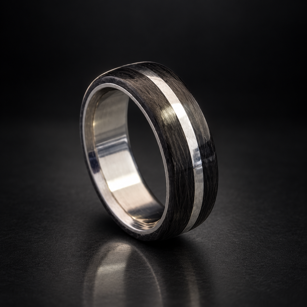 Titan Oracle handcrafted carbon fiber and titanium ring on a dark studio background