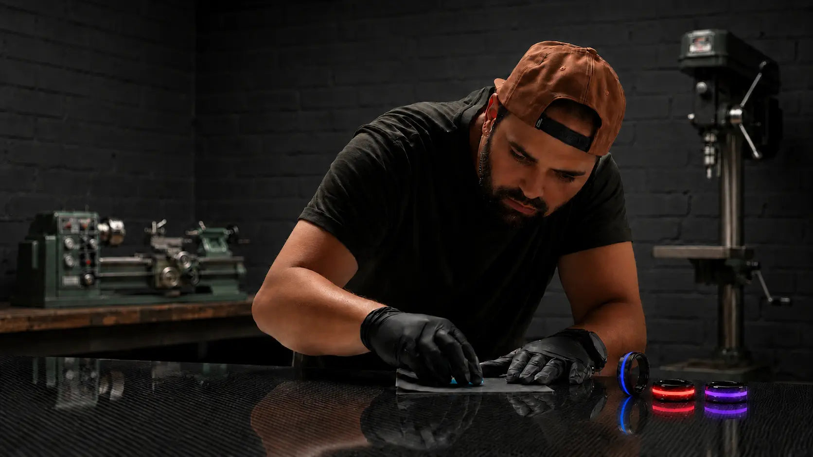 Tyler Wright hand-finishing a glow ring in the Rune Refinery workshop